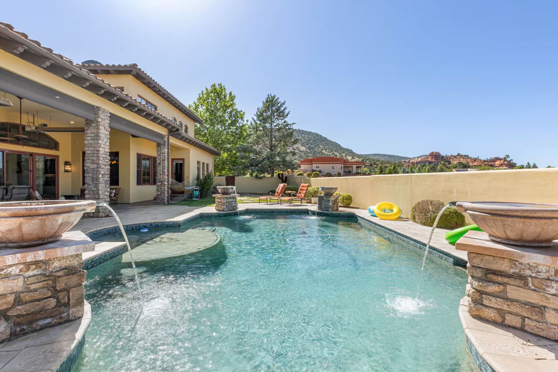 The retreat home's pool with fountain bowls and red rock views